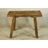 An 18th century rustic pine table raised on four splayed supports. H.69 W.90cm.