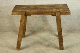 An 18th century rustic pine table raised on four splayed supports. H.69 W.90cm.