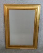 A contemporary gold painted rectangular wall mirror. H.76 W.52cm