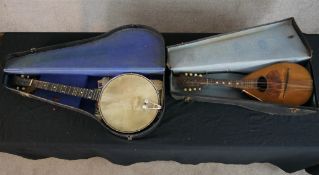 A four string banjo together with an inlaid walnut backed lute, both cased. H.78 W.30 D.10cm largest