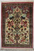 A Persian/Iranian silk qum rug, the central ivory field with tree of life within geometric and