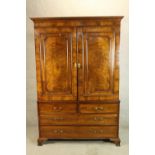 A 19th century mahogany linen press, the twin panel doors opening to reveal hanging rail and