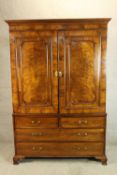 A 19th century mahogany linen press, the twin panel doors opening to reveal hanging rail and