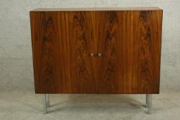 A vintage twin door hardwood cabinet raised on four square chrome plated supports. H.86 W.99cm.