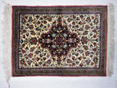 A Persian/Iranian silk Qum (Qom) rug, the central blue lobed panel in ivory field with stylised