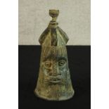 A Japanese possibly Edo period cast bronze bell modelled in the form of a stylised head. H.36cm.