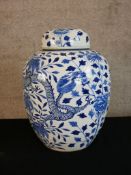 A large 19th century Chinese blue and white porcelain jar and cover decorated with four claw