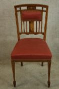 An Edwardian inlaid mahogany pierced splat back chair with red upholstered stuffover seat raised