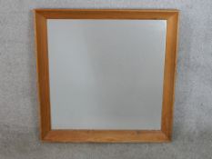 A contemporary pine framed square wall mirror. H.70 W.70cm