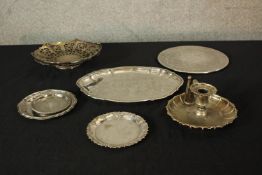 Assorted silver plated items to include a chamberstick, dishes and a pierced basket with swing