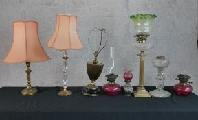 A 19th century brass Corinthian column oil lamp raised on square stepped base together with other