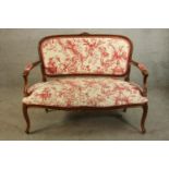 A 19th/early 20th century French style mahogany show framed upholstered open arm settee raised on