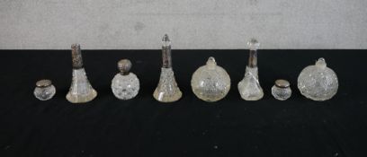 A collection of eight silver mounted and cut glass scent bottles. H.15 W.6 D.6cm largest
