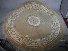 A 20th century Chinese beige ground circular carpet, embroidered with floral decoration. W.270 D.