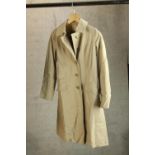 A modern gentlemens Burberry trench coat, with original label.
