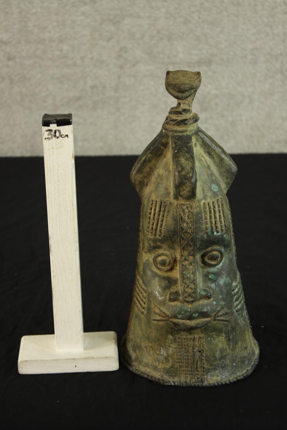 A Japanese possibly Edo period cast bronze bell modelled in the form of a stylised head. H.36cm. - Image 2 of 4