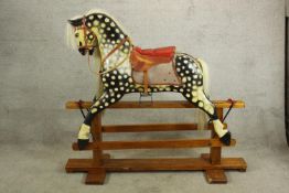 An early 20th century Collinson rocking horse, painted in dapple grey with red leather seat and