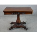 A William IV mahogany foldover card table with central faceted octagonal column support raised on