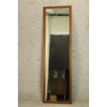 A 20th century teak framed rectangular wall mirror. H.168 W.48cm.