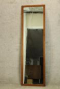 A 20th century teak framed rectangular wall mirror. H.168 W.48cm.
