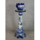 A late 19th blue and white painted jardinere stand raised on four shaped scroll feet, together