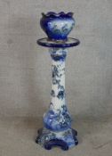 A late 19th blue and white painted jardinere stand raised on four shaped scroll feet, together