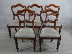 A set of five 19th century mahogany framed bar back dining chairs with drop in seats, raised on