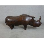 In the manner of Liberty & Co, a brown leather standing Rhino (tail detatched) H.43 W.110 D.32cm