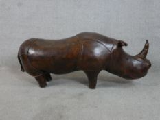 In the manner of Liberty & Co, a brown leather standing Rhino (tail detatched) H.43 W.110 D.32cm