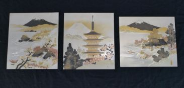 A set of three 20th century Japanese mixed metal panels depicting Mount Fuji, Cherry blossoms of