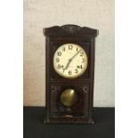 An early 20th century carved pine mantle clock the white dial with black painted Arabic numerals,