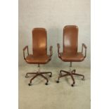 A pair of contemporary brown leather and metal painted metal framed open arm desk chairs raised on