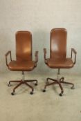 A pair of contemporary brown leather and metal painted metal framed open arm desk chairs raised on