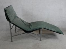 After Tord Bjorklund, a 1970s leather chaise longue/day bed raised on chrome plated tubular supports