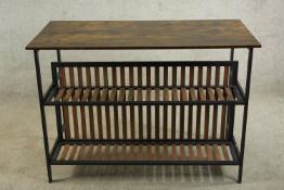 A contemporary metal framed and hardwood console table with slatted shelves below raised on square