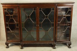 A 19th century mahogany breakfront four glazed door display cabinet; the central two doors opening