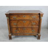 A 19th century mahogany chest of three long drawers, with brass swing handles, turned column