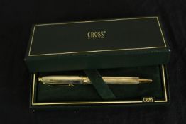 A boxed Cross Sterling silver rollerball pen with engine turned decoration. L.18cm.