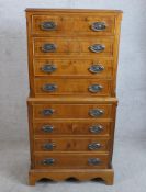 A Georgian style yew chest on chest of eight drawers raised on shaped bracket feet. H.121 W.57 D.