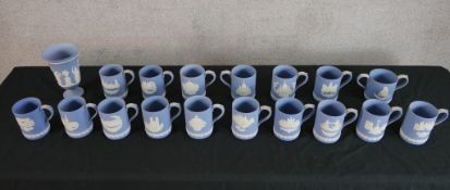 Seventeen Wedgwood blue Jasperware tankards together with a Wedgwood blue Jasperware vase, each with