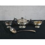 A 20th century silver plated three teaset together with a silver plated soup ladle. H.8 W.35 D.6cm