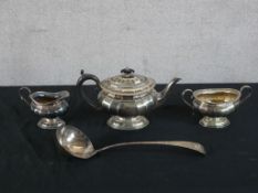 A 20th century silver plated three teaset together with a silver plated soup ladle. H.8 W.35 D.6cm