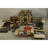 A 20th century tin plated model trainset together with assorted buildings, trains and track. H.58