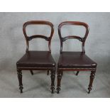 A pair of 19th century mahogany framed balloon back dining chairs with leather studded stuff over
