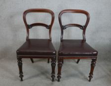 A pair of 19th century mahogany framed balloon back dining chairs with leather studded stuff over