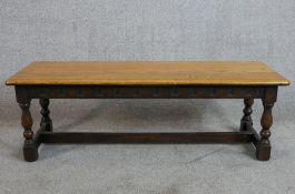 A 19th century carved oak refectory style bench with plank seat. H.30 W.92 D.30cm