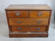 An Edwardian walnut chest of two short over two long drawers raised on plinth base. H.82 W.106 D.