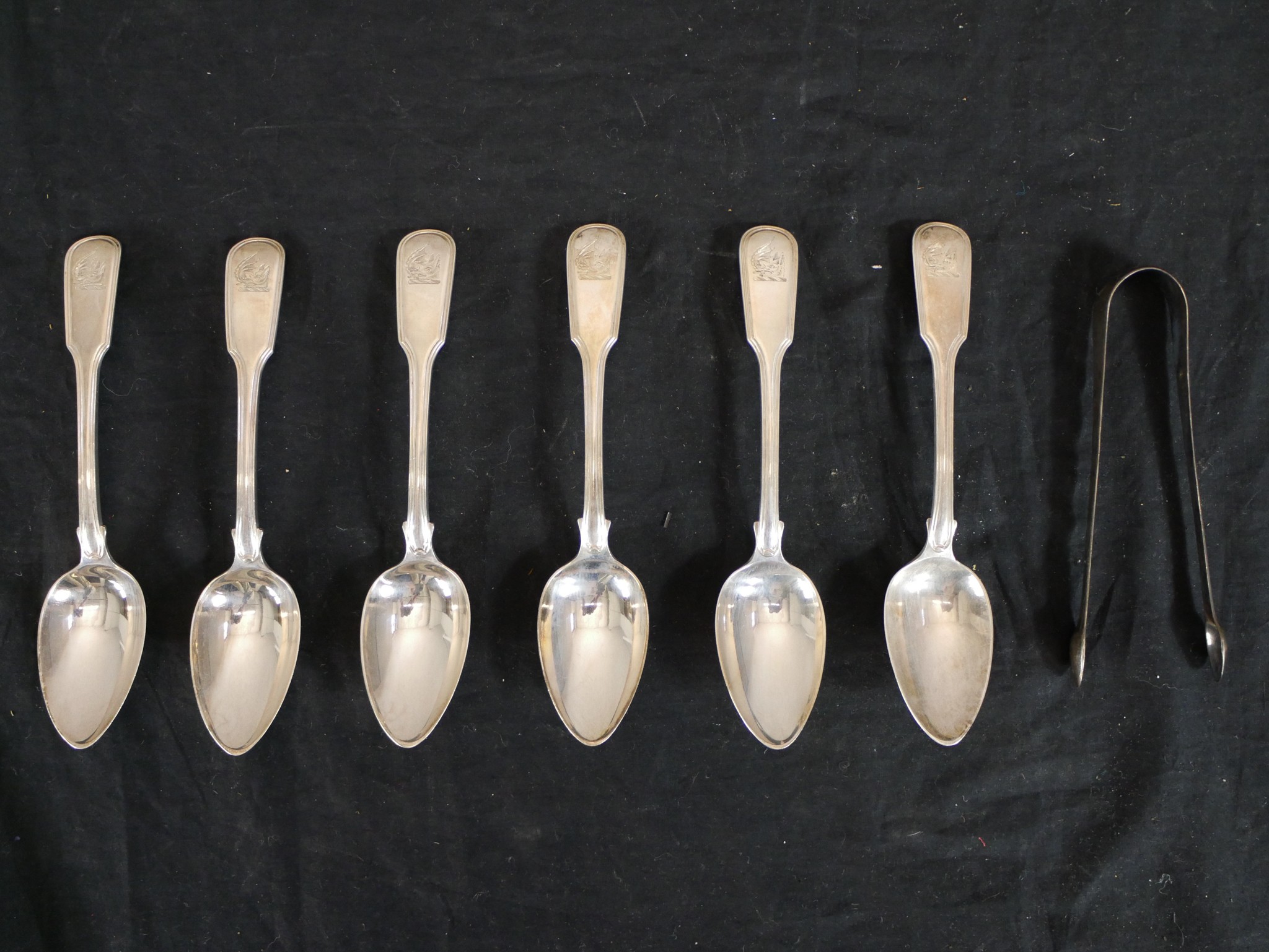 A set of six George III hallmarked silver fiddle pattern crested spoons, William Eaton, London