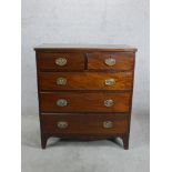 A George III mahogany chest of two short over three long drawers with brass swing handles raised