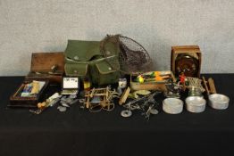 A large assortment of various contemporary fishing accessories to include reels, fly's and other